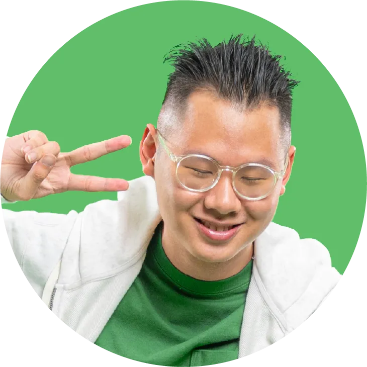 a man with glasses making a peace sign